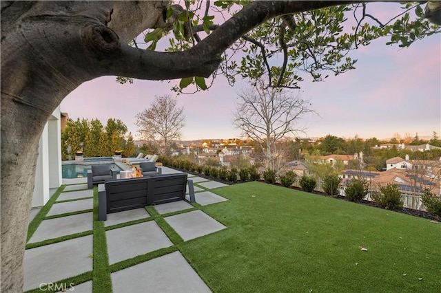 yard at dusk with an outdoor fire pit and a patio area