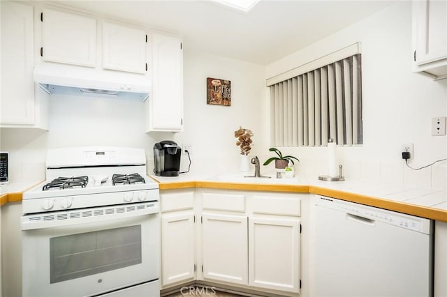 kitchen with white cabinets, white appliances, and sink