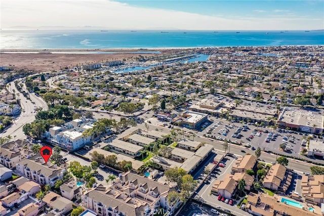 bird's eye view featuring a water view and a beach view