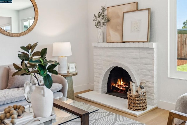 interior space featuring hardwood / wood-style flooring, plenty of natural light, and a fireplace