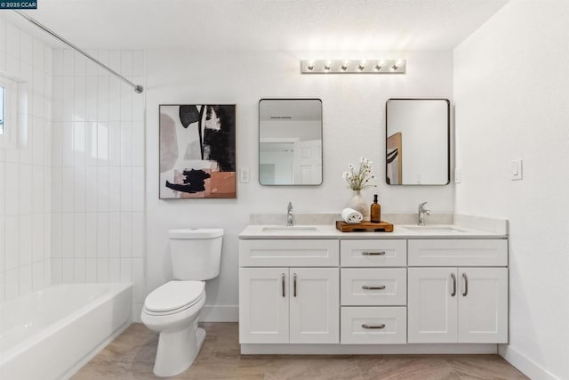 full bathroom with tiled shower / bath combo, toilet, and vanity