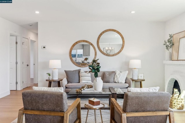 living room featuring light hardwood / wood-style floors and an inviting chandelier