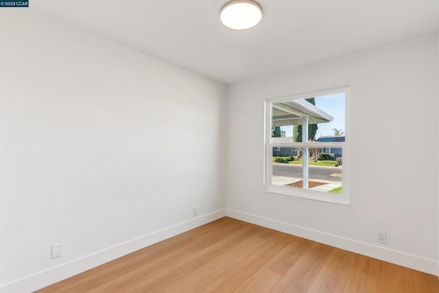 empty room with hardwood / wood-style flooring