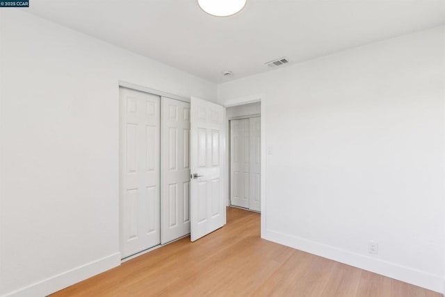 unfurnished bedroom featuring hardwood / wood-style flooring