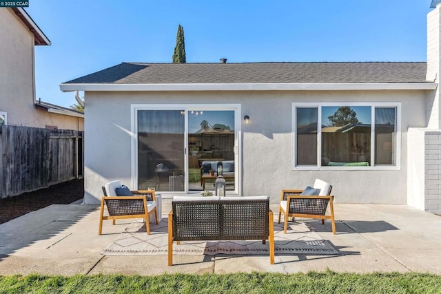 back of property featuring an outdoor living space and a patio area