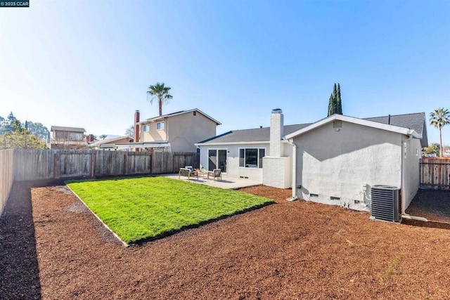 rear view of property with cooling unit, a patio area, and a lawn