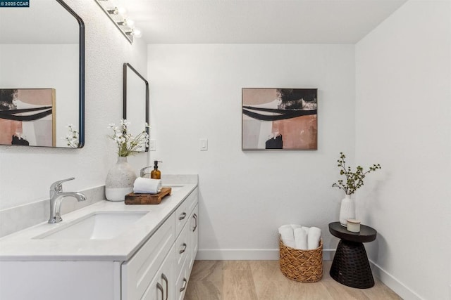 bathroom with hardwood / wood-style floors and vanity