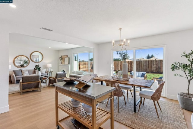 dining room featuring an inviting chandelier and light hardwood / wood-style flooring