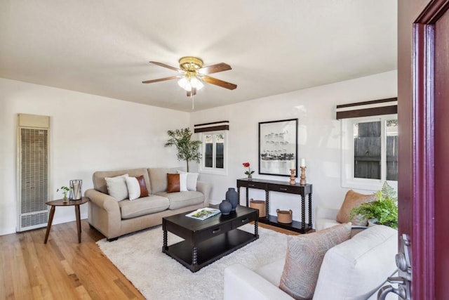 living room featuring ceiling fan and light hardwood / wood-style floors