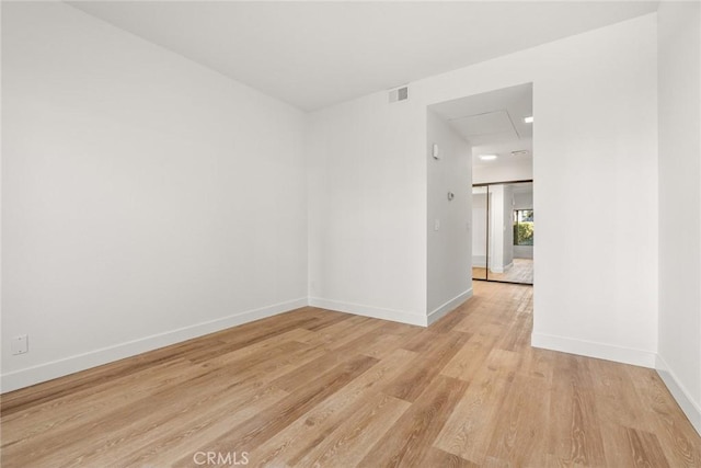 unfurnished room with light wood-type flooring