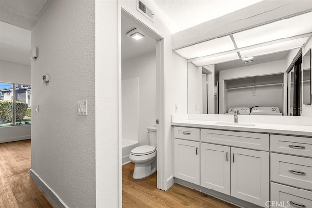 bathroom with vanity, toilet, and hardwood / wood-style floors