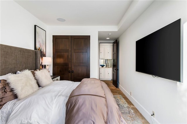 bedroom featuring wood-type flooring and ensuite bathroom