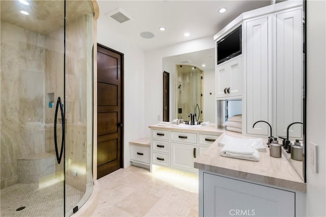 bathroom featuring walk in shower and vanity