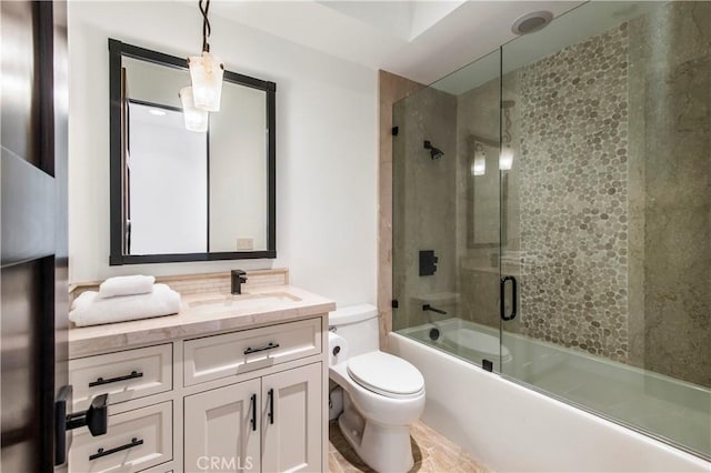 full bathroom with vanity, toilet, and bath / shower combo with glass door