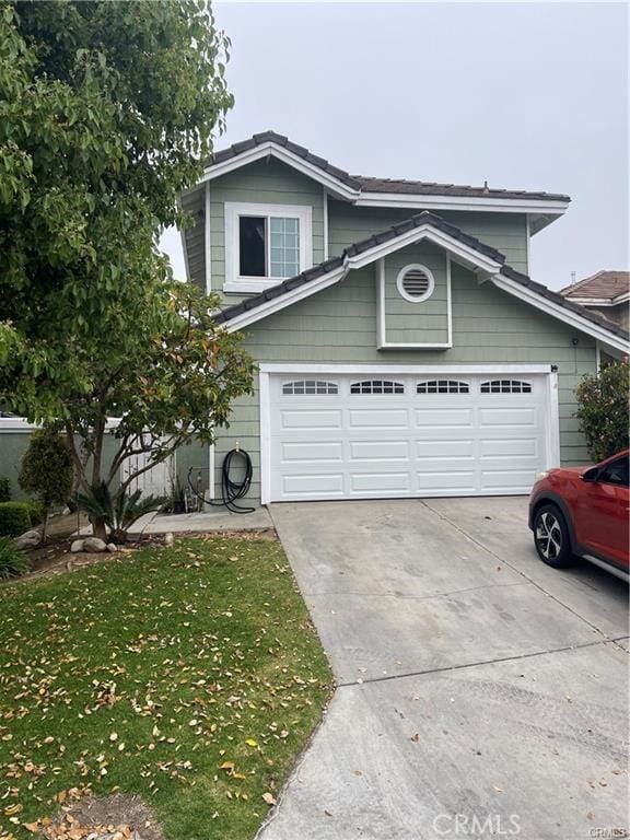 view of front facade featuring a garage and a front lawn