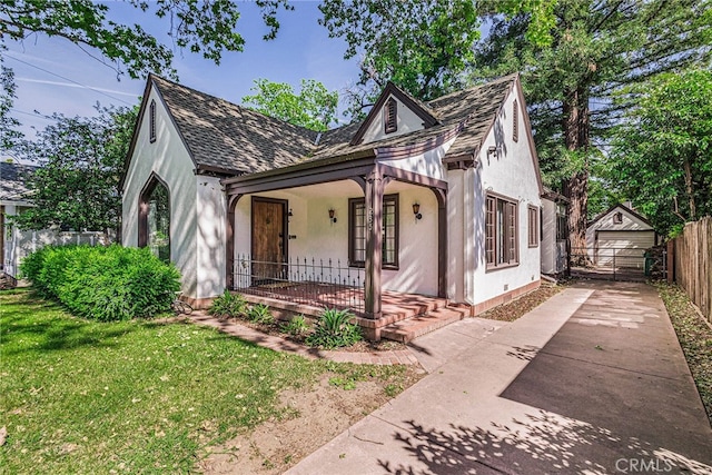 view of front of home with a porch, a garage, and a front yard