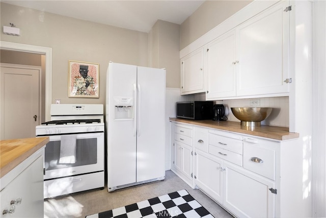 kitchen featuring white cabinets and white appliances