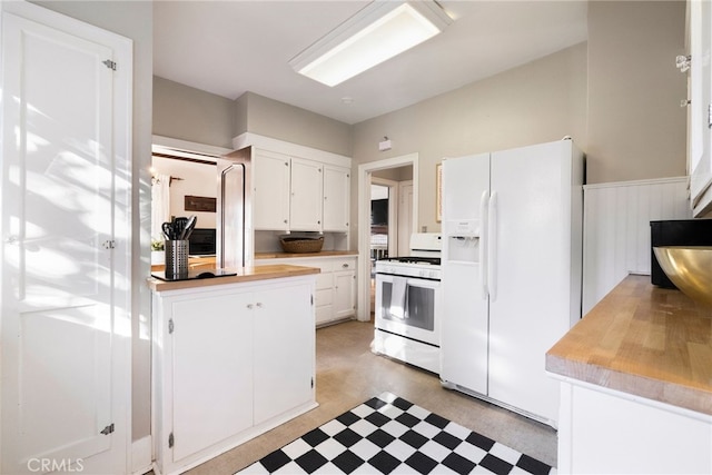 kitchen with white appliances and white cabinets