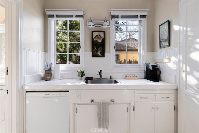 bar with white cabinetry, dishwasher, a healthy amount of sunlight, and tile countertops