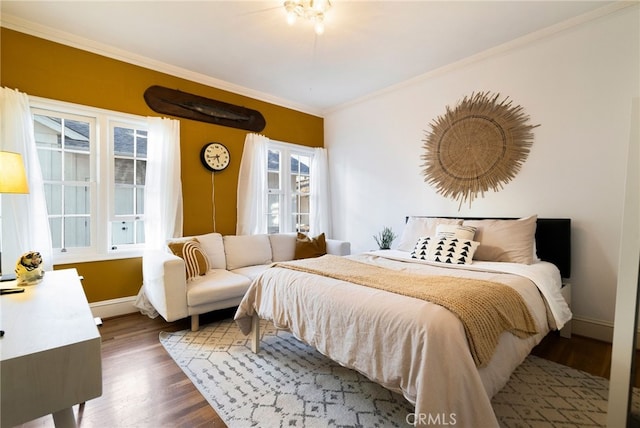 bedroom featuring crown molding and dark hardwood / wood-style floors