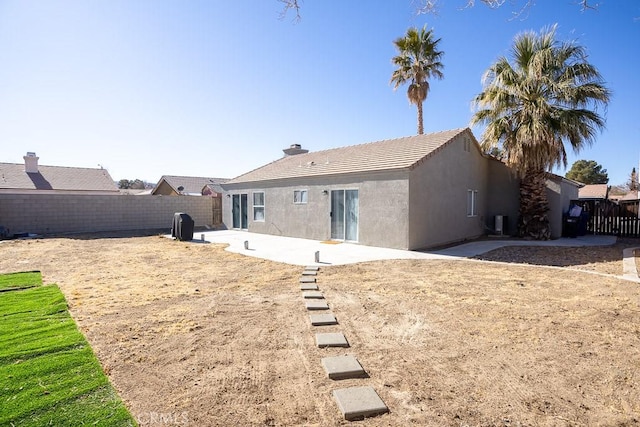 back of property with a patio area and central AC