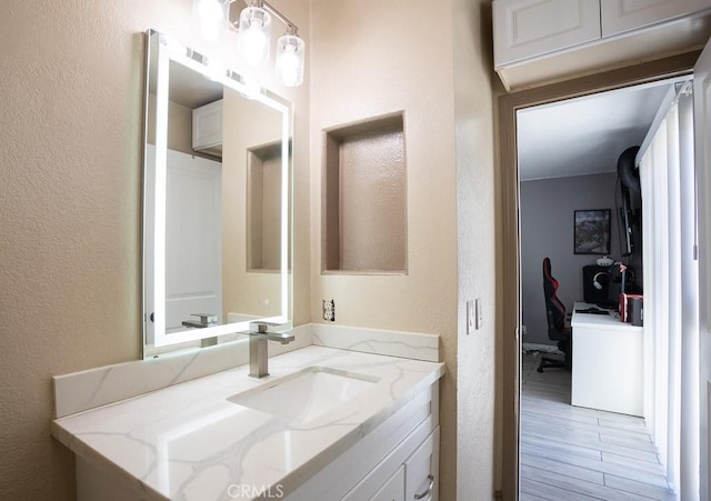 bathroom with hardwood / wood-style flooring and vanity