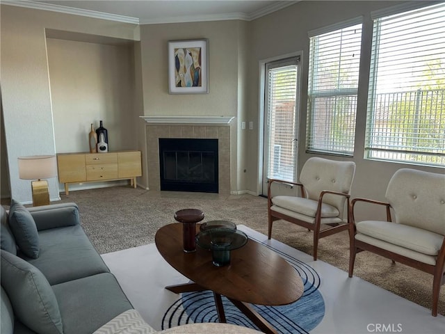 carpeted living room with ornamental molding and a tiled fireplace