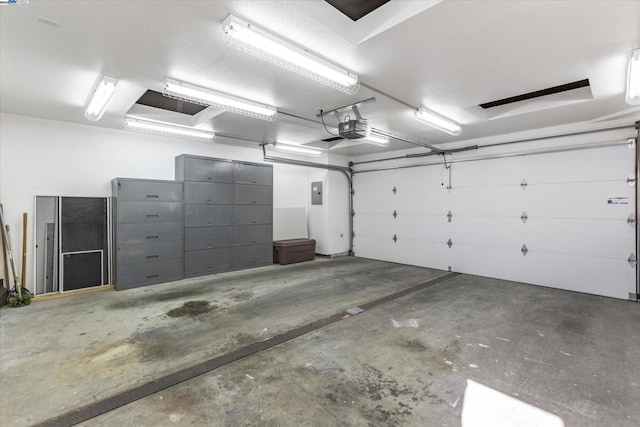 garage with electric panel and a garage door opener