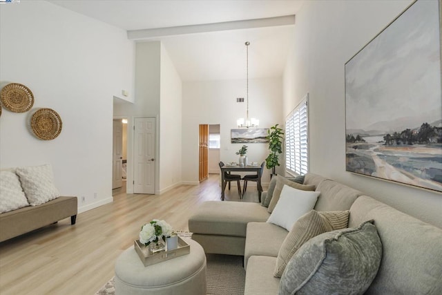 living room with high vaulted ceiling, beam ceiling, a notable chandelier, and light wood-type flooring