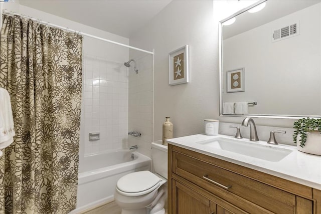 full bathroom featuring shower / bath combo, toilet, and vanity