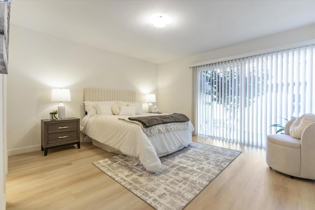 bedroom with hardwood / wood-style flooring and access to exterior