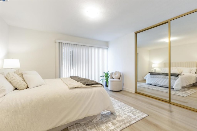 bedroom featuring light hardwood / wood-style floors and a closet