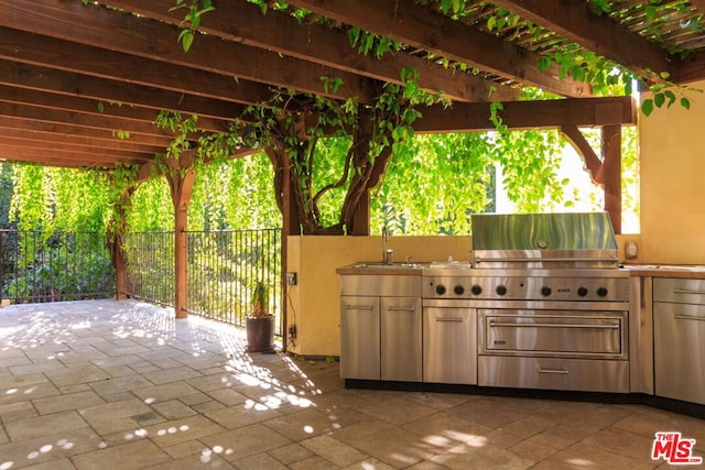 view of patio / terrace featuring sink, area for grilling, and a pergola