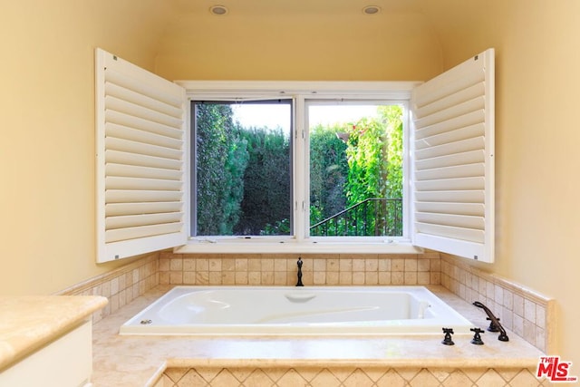 bathroom with a relaxing tiled tub