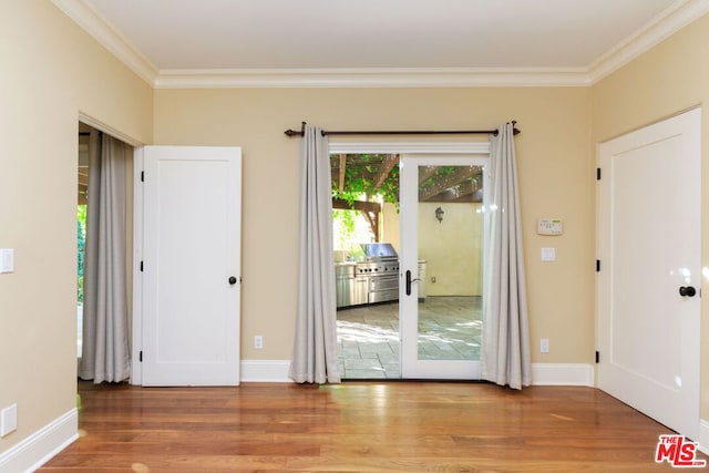 interior space with hardwood / wood-style flooring and ornamental molding