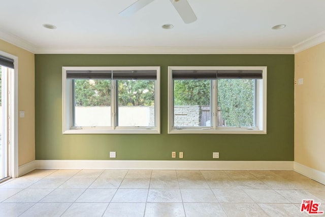 tiled spare room featuring ceiling fan and ornamental molding