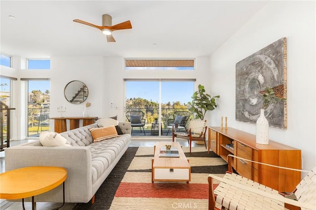 living room featuring ceiling fan and a wealth of natural light