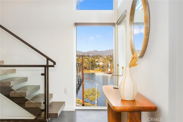 doorway to outside featuring a water and mountain view