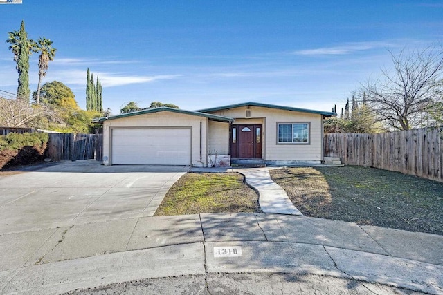 ranch-style house with a garage and a front lawn