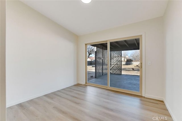 spare room featuring light hardwood / wood-style flooring