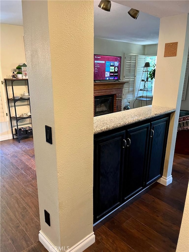 bar with dark hardwood / wood-style floors