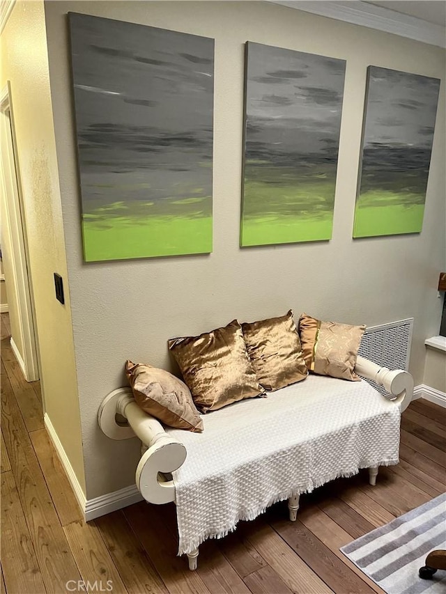 bedroom with hardwood / wood-style flooring and ornamental molding