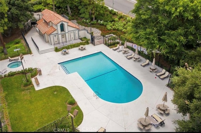 view of swimming pool featuring a patio area and a yard