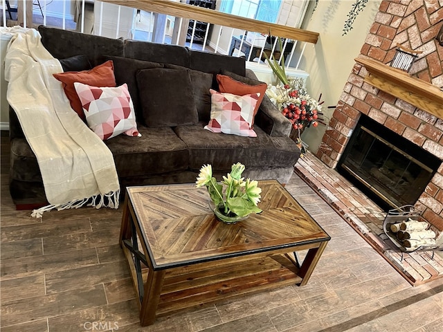 living room with hardwood / wood-style flooring and a fireplace