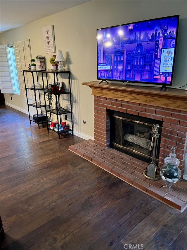 living room featuring a brick fireplace and hardwood / wood-style floors