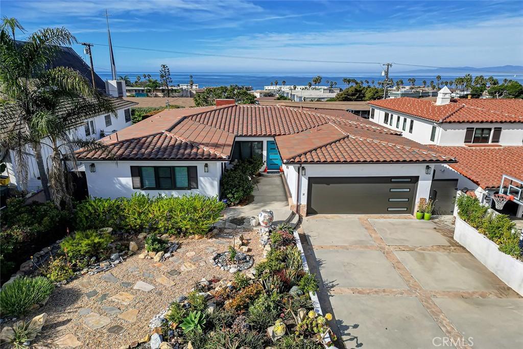 view of front facade featuring a garage and a water view