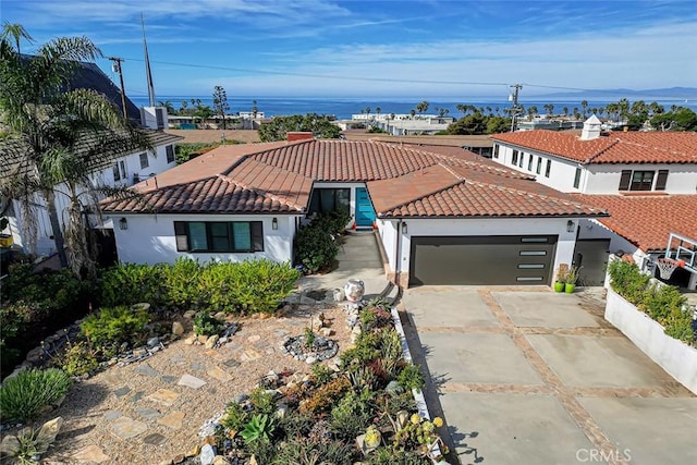 view of front facade featuring a garage and a water view