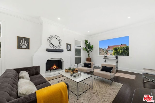 living room featuring hardwood / wood-style flooring and crown molding