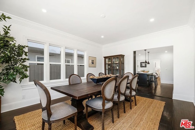 dining area featuring ornamental molding and dark hardwood / wood-style floors