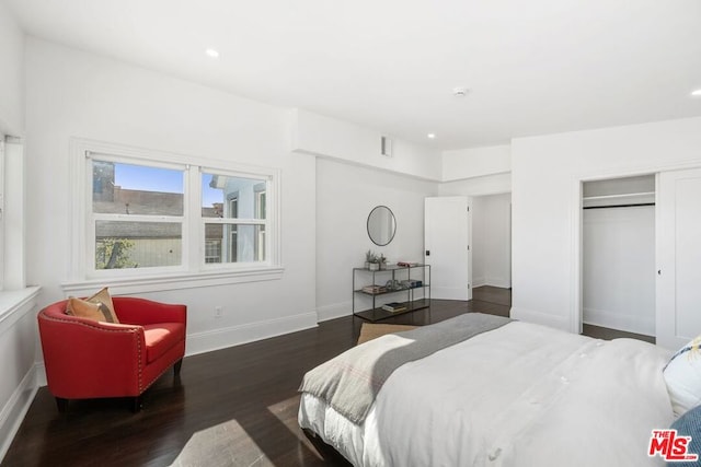 bedroom featuring dark hardwood / wood-style floors and a closet